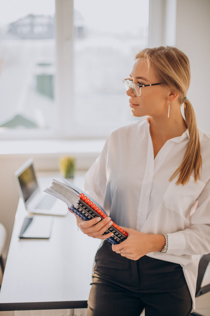 A professional and approachable accountant discussing financial strategies with a satisfied client in a modern office setting, conveying trust and expertise, neutral colors, clean and organized environment, focused on the interaction between the accountant and client, no distracting elements, high-quality and realistic representation